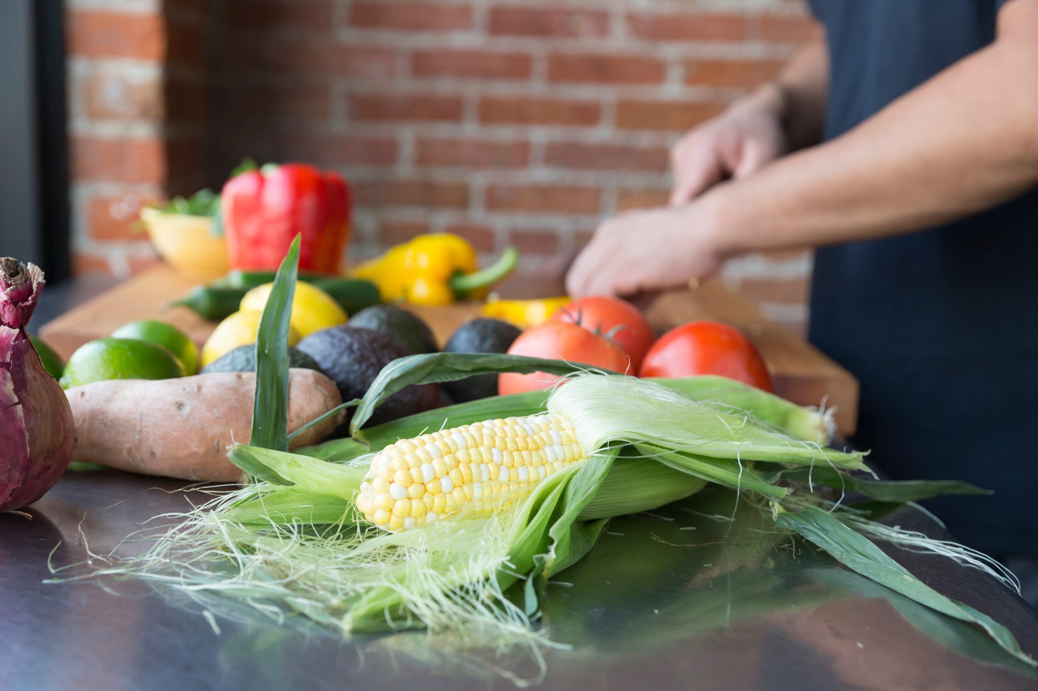 Chef chopping vegetables on a counter.